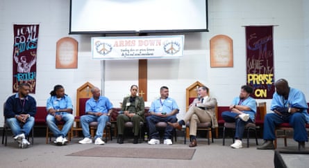 eight people sitting down indoors on a panel