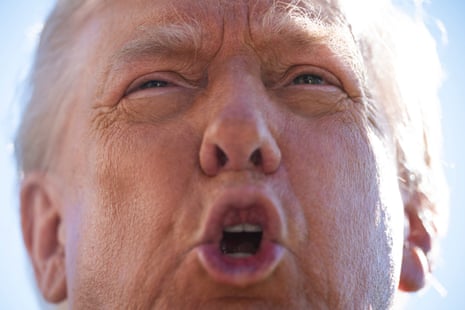 Extreme close-up of Donald Trump's face with his mouth open, squinting in sunlight