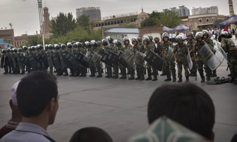 Chinese soldiers in riot gear stand outside a mosque in Kashgar, in Xinjiang province.