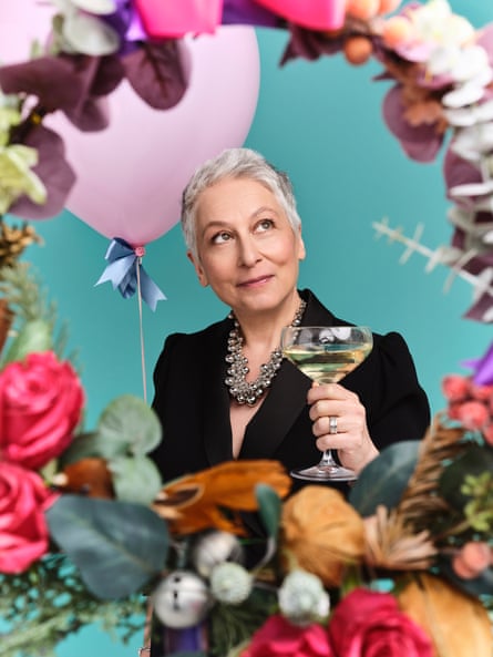 Annalisa Barbieri wearing a black outfit and large silver necklace, and holding a champagne saucer