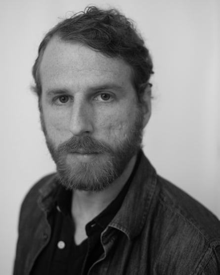 Black and white portrait of a man in button-down shirt looking ahead