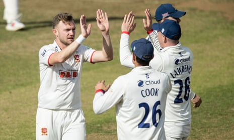 Sam Cook (left) celebrates taking another wicket with his namesake and Essex teammate Alastair Cook.