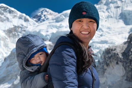 Pasang with her son in a backpack