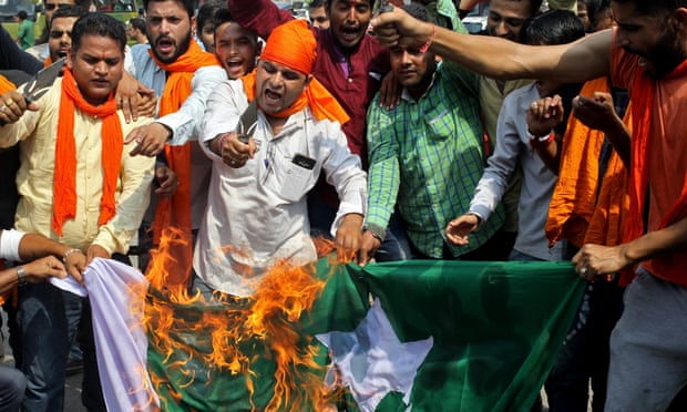 Indian protesters burn Pakistan’s flag.