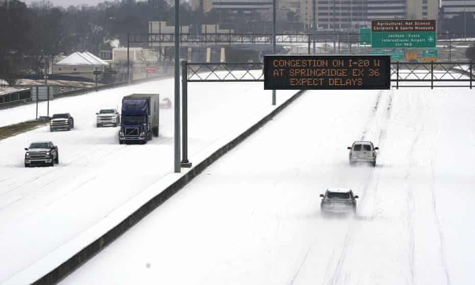 Drivers in Mississippi drive through highways thick with snow during extreme weather in February