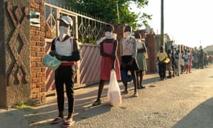 A queue forms outside Samantha Murozoki’s home in Chitungwizaon May 5, 2020, where, with the help of volunteers, Samantha Murozoki serves over a 100 hot meals per day from her home to families whose household income has been cut off by closure of all informal markets during the lockdown