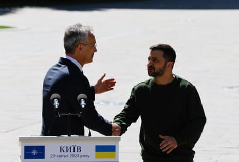 Ukrainian president Volodymyr Zelenskiy (R) and Nato secretary general Jens Stoltenberg (L) shake hands after a joint press conference in Kyiv on Monday.