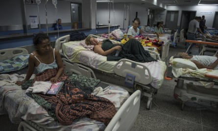 Patients lie on beds in the emergency room of a hospital in Barquisimeto, Venezuela.