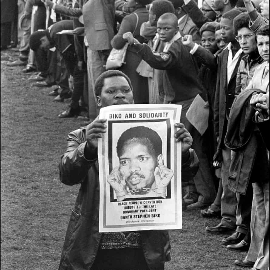 Um homem segura uma fotografia do líder estudantil sul-africano Steve Biko, no seu funeral na Cidade do Rei Guilherme, 1977.