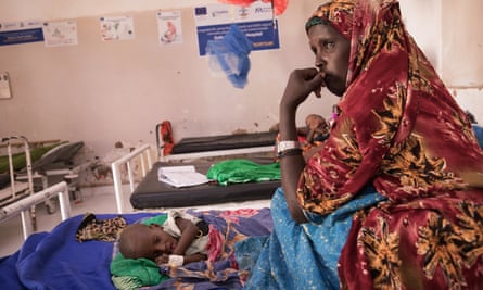 Nimo Hassar rests on the mattress next to her seven month old baby, Abdikadir at the South Galkayo Hospital where UNHCR support a stablisation centre to treat acute malnutrition. 42 children were admitted to the ward in November. Malnutrition rates in the Muldug region is the highest in Somalia - 52% of under fives.