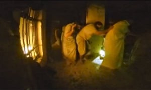 A still image taken from helmet camera video footage on 22 October shows freed prisoners moving in line during a raid by US and Kurdish special forces on a compound in northern Iraq.