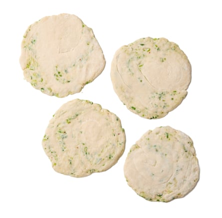 Felicity Cloake’s Taiwanese scallion or spring onion pancake 10. Starting with the first pancake, flatten it slightly, then roll it out into a thin disc.