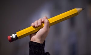 A giant pencil is held up at a vigil outside The French Institute in London on 9 January 2015 for the 12 victims of the attack on the Paris offices of satirical weekly Charlie Hebdo.