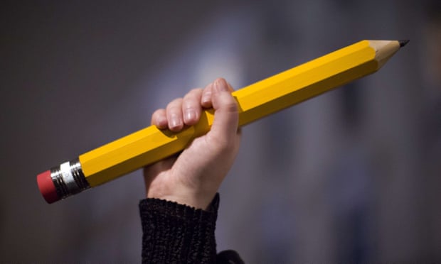 A giant pencil is held up at a vigil outside The French Institute in London on 9 January 2015 for the 12 victims of the attack on the Paris offices of satirical weekly Charlie Hebdo. 