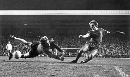Phil Thompson shoots past Stromsgodset goalkeeper Inge Thun to score Liverpool’s third goal.