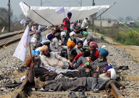 Farmers block railway tracks during a protest in Devi Dass Pura, a village near Amritsar in the Indian state of Punjab