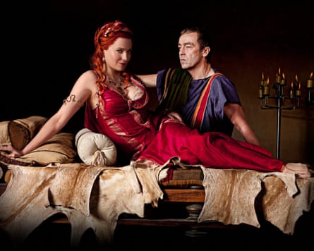 Lawless and Hannah in Roman costume reclining on a chaise longue