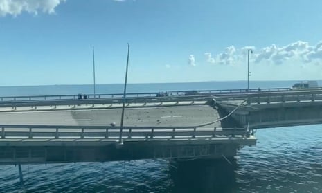 A view of the Crimea bridge shows a section of the road split and sloping to one side following an alleged attack.