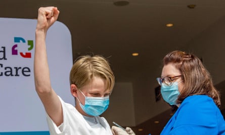 Charles Muro, 13, celebrates being inoculated by nurse Karen Pagliaro in Hartford, Connecticut.