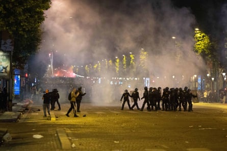 Police clash with supporters on the Champs-Élysées avenue in Paris