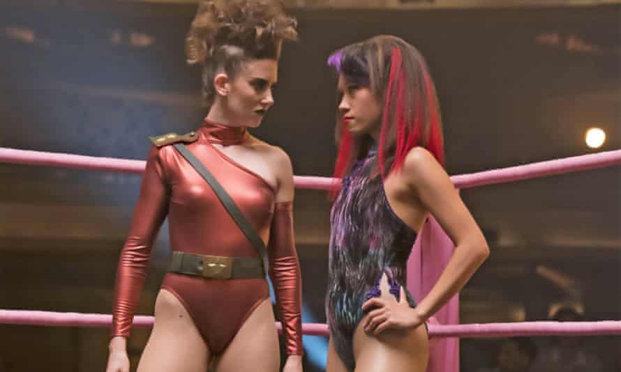 Alison Brie and Ellen Wong in leotards facing each other in a boxing ring, in a scene from Glow.
