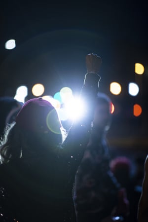A protestor raises their fist as the group stands off with police officers on May 30, 2020 in Louisville, Kentucky. Protests have erupted after recent police-related incidents resulting in the deaths of African-Americans Breonna Taylor in Louisville and George Floyd in Minneapolis, Minnesota.
