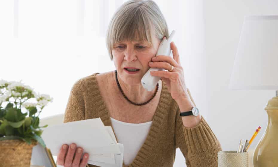 A woman looking worried about paying bills