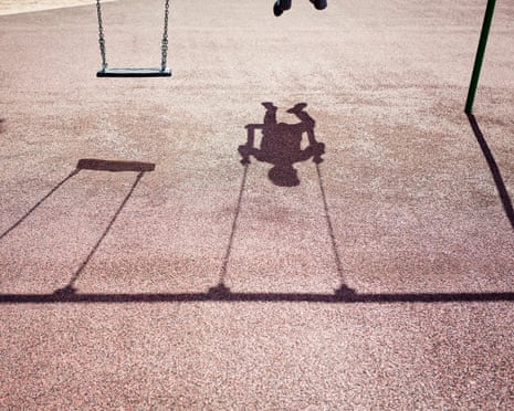 Shadow of a child on a playground swing