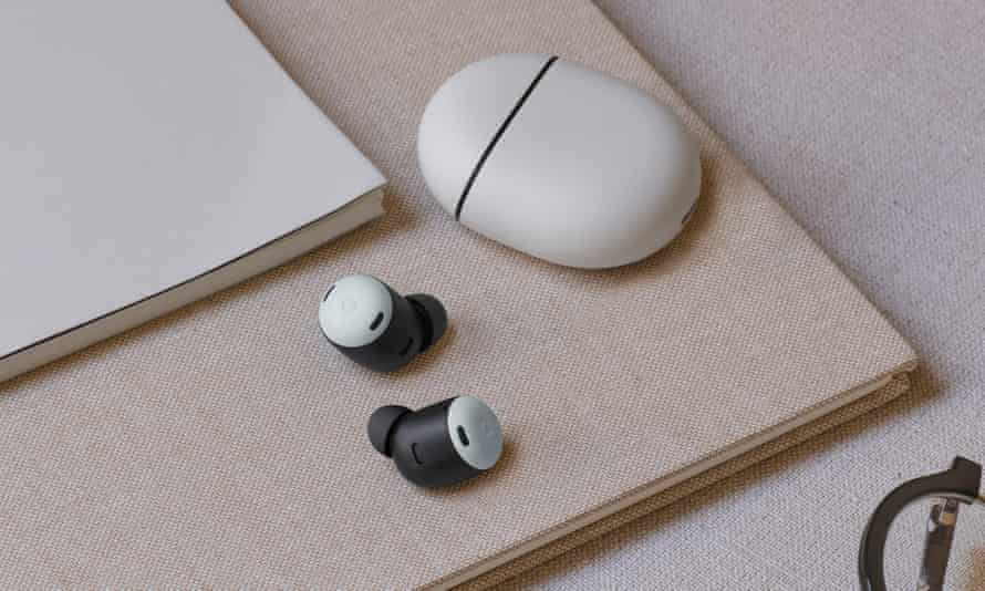 The Pixel Buds Pro and their charging case resting on a book on a desk