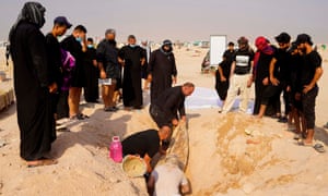 An Iraqi family digs up the body of a relative at a coronavirus cemetery outside the Shiite holy city of Najaf.