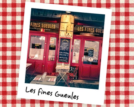 An instant photo of the exterior of a restaurant with red glazed doors and tables outside, against a red gingham background.