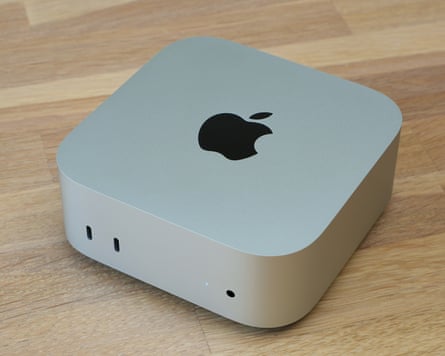 The Apple Mac mini M6 shot from the top at an angle showing the Apple logo and front ports.