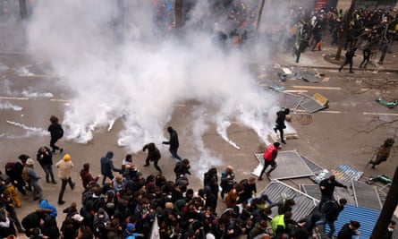 Protesters kick away teargas canisters