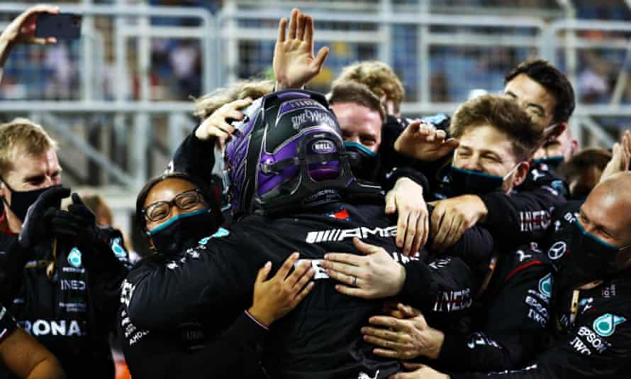 Lewis Hamilton embraces his Mercedes team after sealing a stunning win at the Bahrain Grand Prix.