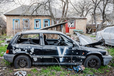 A car destroyed by Russian troops and marked with the pro-Russia ‘V’ symbol.
