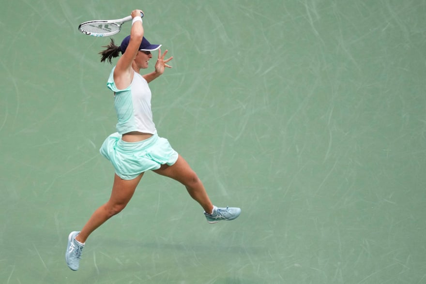 Iga Swiatek fires down a fierce forehand during the second-set tiebreaker against Ons Jabeur.