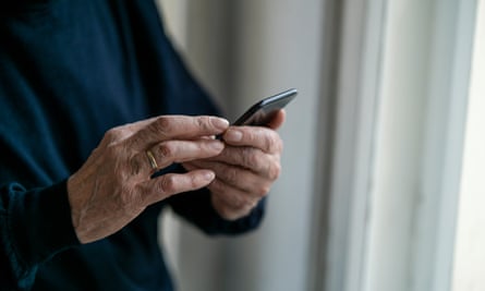 Closeup of senior man using mobile at home