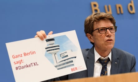 Engelbert Luetke-Daldrup, head of BER airport, holds a sign reading ‘All of Berlin says: #Thanks TXL’ as he addresses a news conference in Berlin on 29 September.
