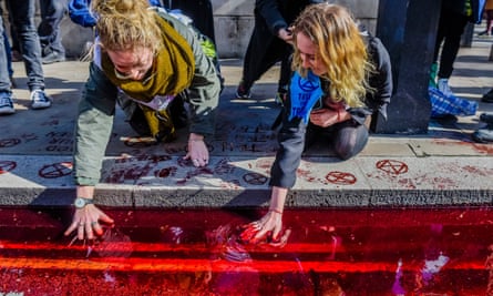 Extinction Rebellion activists pour 200 litres of (artificial) blood outside Downing Street.