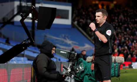 Michael Oliver checks the VAR pitchside monitor before showing a red card to Crystal Palace’s Luka Milivojevic in the FA Cup.