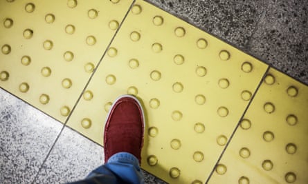 yellow blind ground with red shoe in metro station