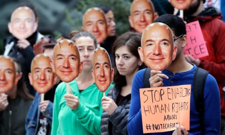 protesters agains amazon wearing jeff bezos masks in seattle in october 2018