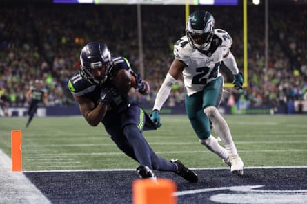 Jaxon Smith-Njigba of the Seahawks catches a touchdown pass as James Bradberry of the Eagles defends in the last minute of Monday’s game at Lumen Field.