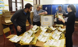 Counting ballot papers in a polling station in Milan.