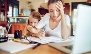 Close up of a mother going through her work while looking after her young daughter