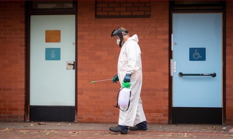 A worker disinfects public toilets in Leicester. Local council commercial losses during the pandemic look set to hit jobs and services. 
