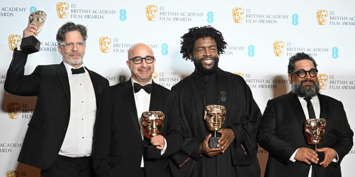 American producer David Dinerstein, American producer and screenwriter Robert Fyvolent, American drummer Ahmir Khalib Thompson aka Questlove and American documentary producer Joseph Patel pose with their awards for a documentary for Summer of Soul.