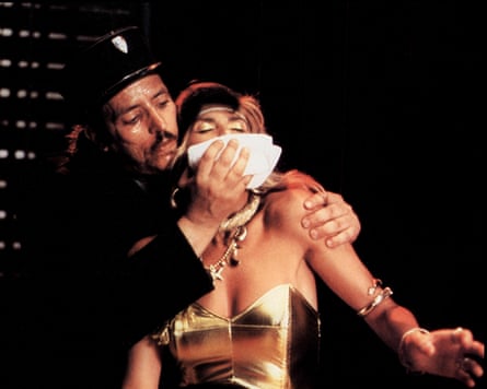 He grabs her from behind and incapacitates her, putting a white handkerchief over her mouth