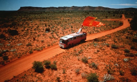 Priscilla being driven on an outback road in a scene from the film