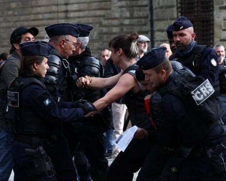 French CRS riot police carry out checks on protesters before a demonstration in Nantes.